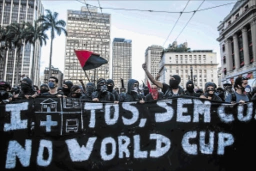 ANGRY: Protesters demonstrate against the staging of the upcoming 2014 World Cup in Sao Paulo, Brazil, on Saturday. More demonstrations were planned in 36 Brazilian cities against the billions in spending for the tournament, which begins on June 12Photo: Victor Moriyama/Getty Images