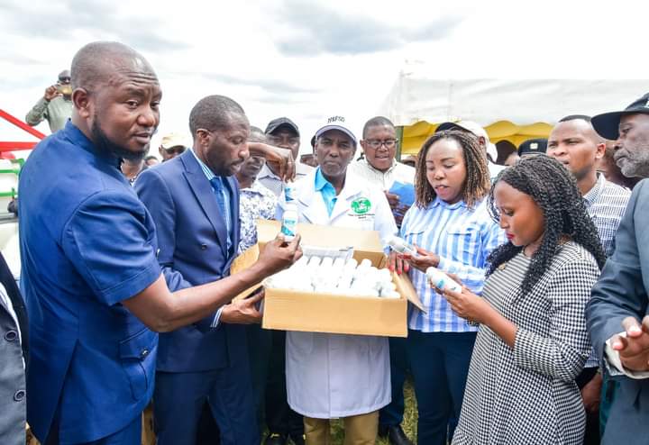 Agriculture Principal Secretary Kello Harsama hands over the Biograde 300 SL pesticide to Kirinyaga county leaders during the launch of the pesticide at the Mwea Irrigation scheme.