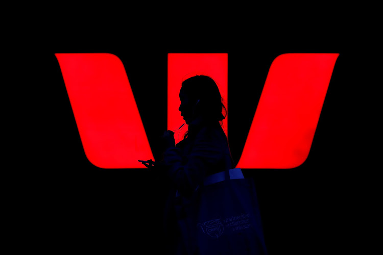 A woman walks past a logo of Australia's Westpac Bank in Sydney, Australia. REUTERS/STEVEN SAPHORE