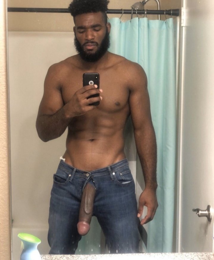 Marshall Price taking a shirtless mirror selfie in blue jeans with his hard fat cock hanging out of the zipper