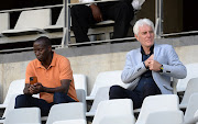 Bafana Bafana coach Hugo Broos and his assistant coach Helman Mkhalele attend a DStv Premiership game between Cape Town City and Baroka FC at Cape Town Stadium in April 2022.
