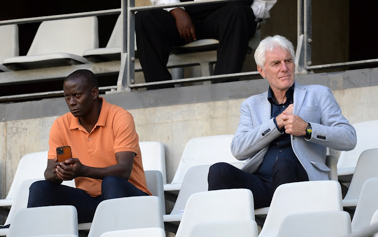 Bafana Bafana coach Hugo Broos and his assistant coach Helman Mkhalele attend a DStv Premiership game between Cape Town City and Baroka FC at Cape Town Stadium in April 2022.