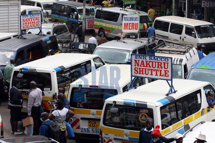 Shuttles heading to Central Kenya wait for passengers along River Road in Nairobi on July 7, 2020