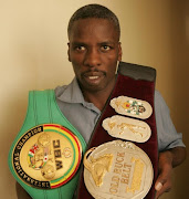 Joseph Makaringe poses with the WBC International and SA welterweight championship belts.