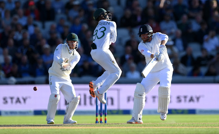 Jonathan Bairstow of England plays a shot as Keegan Petersen of South Africa jumps to avoid the ball and wicket keeper Kyle Verreynne looks on during the second Test in at Old Trafford in Manchester, England, August 25 2022. Picture: SHAUN BOTTERILL/GETTY IMAGES