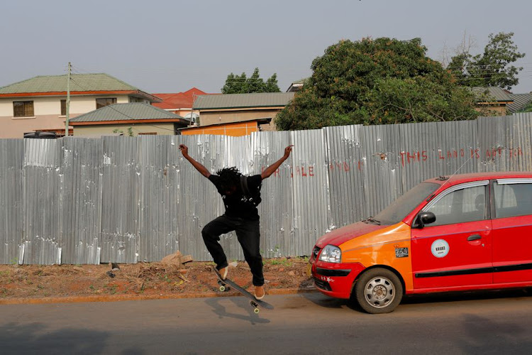 Harmonie Bataka, 27, a skateboarder and skateboarding tutor, practises skateboarding on streets in her neighbourhood in Tema, Ghana, February 13, 2022.