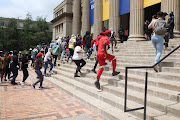 University of the Witwatersrand students rush to enter the Johannesburg institution's Great Hall on March 3 2023, the third day of protest action against the exclusion from registering of students with historical debt.