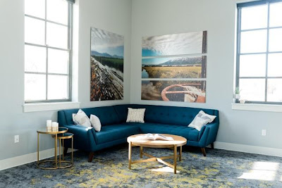 A blue sofa in the corner of a modern Manhattan style apartment.