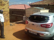 Joseph Ngobeni looks at his bullet riddled car, after police opened fire on his family on Friday night. His 16-year-old granddaughter, Kutlwano, was shot in the left shoulder.