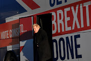 Britain's Prime Minister Boris Johnson steps out of the campaign trail bus as he campaigns for the general election, in Washington, Britain, on December 9 2019. 