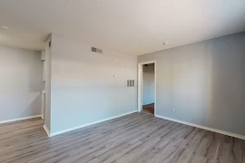 Living area with wood inspired flooring, gray walls and white trim