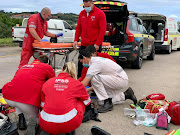 Paramedics work to stabilise an elderly man who was struck by a vehicle on the busy N2 highway near Ballito, in KZN, on Tuesday.