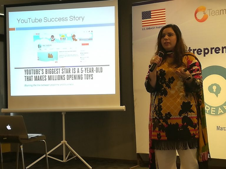 Woman holding a presentation about a YouTube success story.