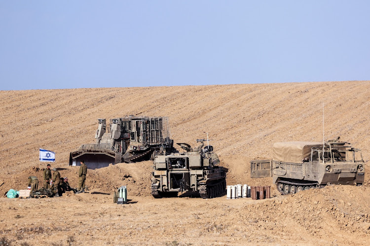 Israeli military vehicles and soldiers from an artillery unit gather near Israel's border with the Gaza Strip, in southern Israel, on October 12 2023. Picture: RONEN ZVULUN/REUTERS