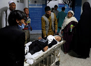 An injured school girl is transported to a hospital after a blast in Kabul, Afghanistan May 8, 2021. 