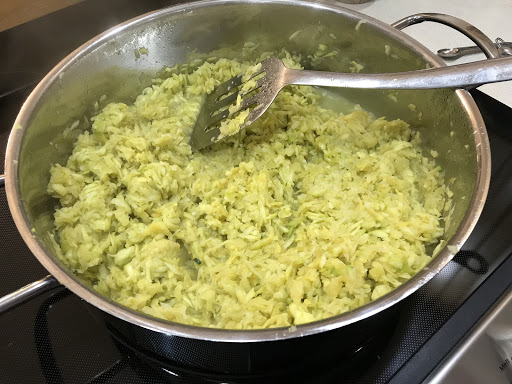 Pan with cooked riced zucchini & yellow squash.