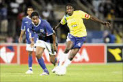 WINDSWEPT: Mamelodi Sundowns' Godfrey Sapula leaves Supersport United's Shane Poggenpoel in his wake in their PSL match at Super Stadium on Saturday. Sundowns won 1-0. Pic. Antonio Muchave. 12/11/2006. © Sowetan.