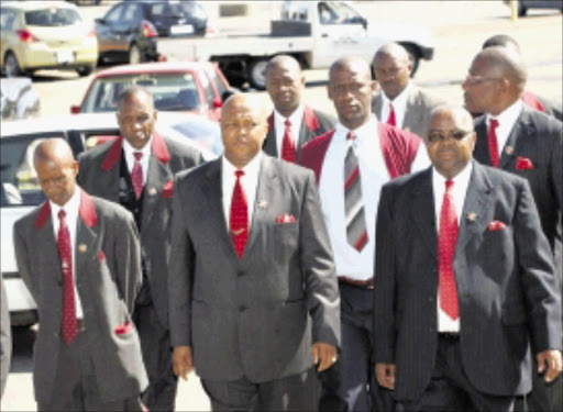 MARATHON CASE: Bethuel Modise, front centre, leader of the International Comforters Holiness Church, and senior members of his denomination, leave the Westonaria magistrate's court yesterday. Pic: Veli Nhlapo. 10/12/2009. © Sowetan.