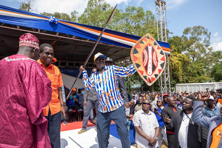 Azimio presidential candidate Raila Odinga posing with a shield and a spear on July 2,2022.