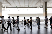 People wait in line to register for the Covid-19 vaccine in Bangkok, Thailand. A wanted man in China was recently bust after lining up for a vaccine.