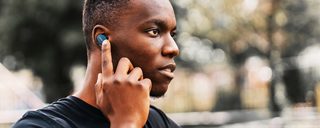 Man using the swipe controls on the Bose Sport Earbuds