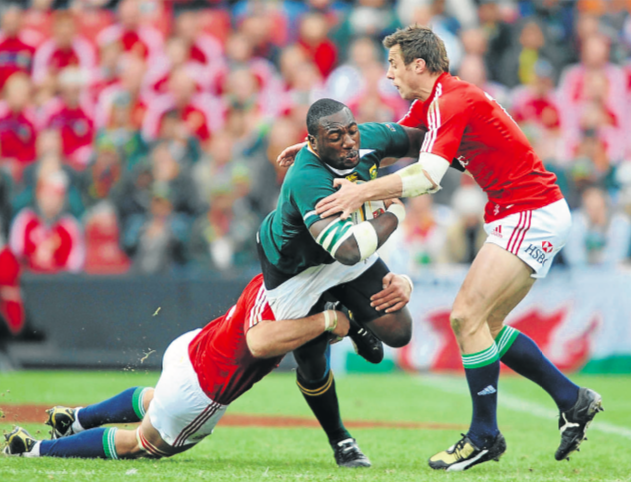 Jamie Heaslip and Tommy Bowe of the Lions tackle Tendai Mtawarira of SA during The British and Irish Lions third Test match at Coca-Cola Park on July 4 2009 in SA.