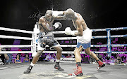 SA junior-middleweight champion Nkululeko Mhlongo jolts Walter Dlamini en route to a fourth-round stoppage to win both the SA and WBA Pan African middleweight belts . /  Nick Lourens