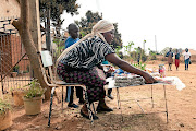 Vendor  Rosemary Mudzamiri arranges her wares in Harare. ‘All we want is a better future,’ she says.