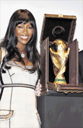 Model Naomi Campbell poses with the World Cup trophy which is presented in its Louis Vuitton travelling case in Paris June 1, 2010. Louis Vuitton and FIFA collaborated on the new travel case for the FIFA World Cup trophy and it will be used for the first time at the World Cup in South Africa. REUTERS/Jacky Naegelen (FRANCE - Tags: SPORT SOCCER WORLD CUP BUSINESS FASHION)