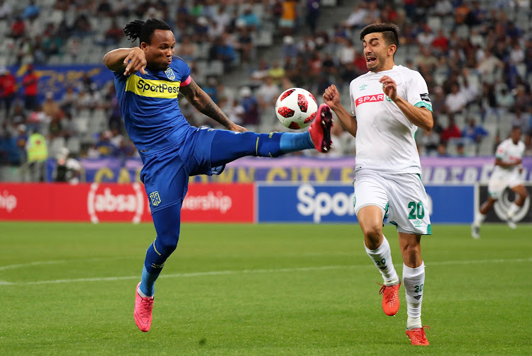 Cape Town City's Mozambican utility player Edmilson Dove (L) challenges AmaZulu's Argentine striker Emiliano Tade during the Absa Premiership match at Cape Town Stadium in Cape Town on October 27, 2018.