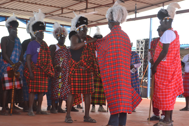 Deputy President William Ruto being dressed by Turkana elders in traditional regalia during a previous Turkana Cultural Festival.