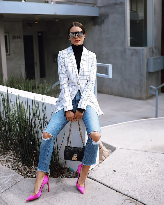 a lady wearing jeans, a striped blazer, and pink shoes for women