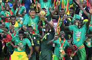 Senegal's Kalidou Koulibaly lifts the trophy as the team celebrates after beating Egypt to win the Africa Cup of Nations at Olembe Stadium, Yaounde, Cameroon on February 6 2022