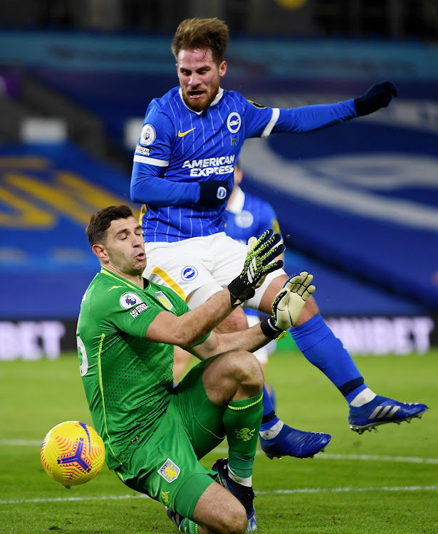 Brighton's Alexis Mac Allister in action with Aston Villa's Emiliano Martinez