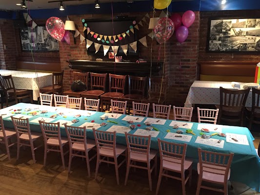 Banquet table and Chiavari chairs arranged for intimate birthday party