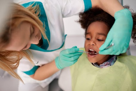 child in a dental chair having dental work done