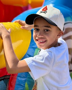 Boy playing on inflatable attraction