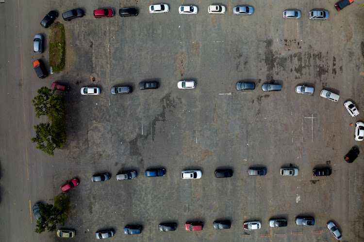 An aerial view of people queuing for a drive-in coronavirus disease (COVID-19) testing site, as the latest Omicron variant emerges as a threat, at Hiram Bithorn Stadium's parking lot in San Juan, Puerto Rico December 23 2021. Picture: REUTERS/RICARDO ARDUENGO