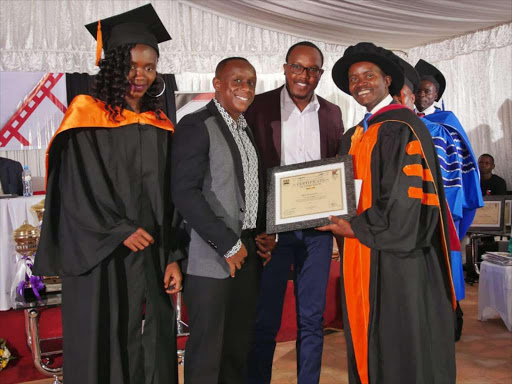 Abel Mutua and Philip Karanja, Directors at Phil-It Productions receive a recognition award from ICT CS Joe Mucheru as film Industry Champions in Kasarani Stadium on February 22, 2019