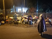 Evictees and their belongings outside the Yellowwood Park civil hall in Durban on Monday night. 