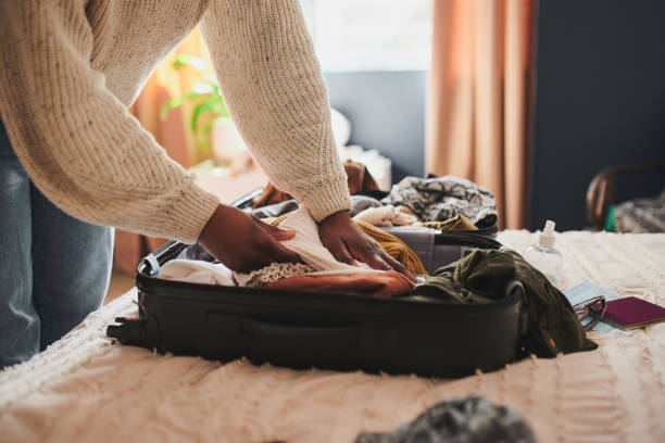 packing folded clothing, plastic shoe boxes