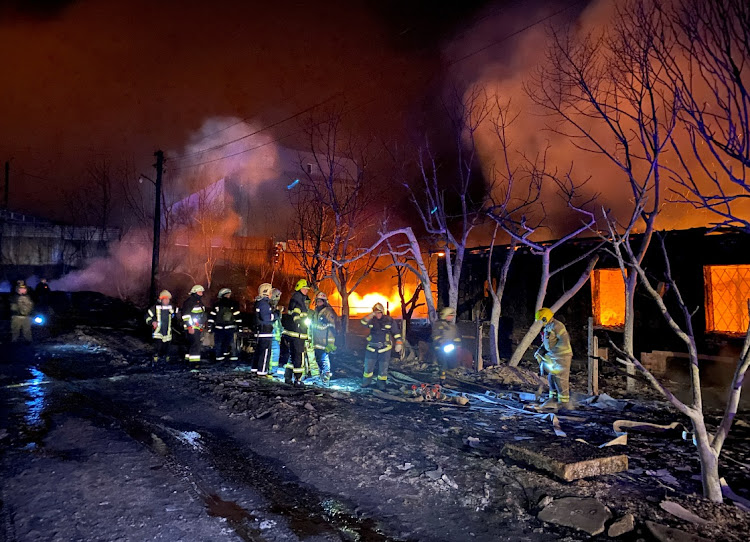 Firefighters work at a site of a Russian drone strike in Kharkiv, Ukraine, on February 10 2024.