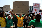 A protester holds up his placard during a protest march in Durban on Monday in opposition to government violating people's freedom of choice