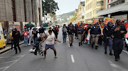 Homeless people danced and cheered when Cosatu marched through the Cape Town streets to hand over a memorandum at the Western Cape legislature and parliament.