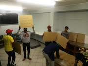 Students prepare posters for a protest at CPUT on Friday morning.