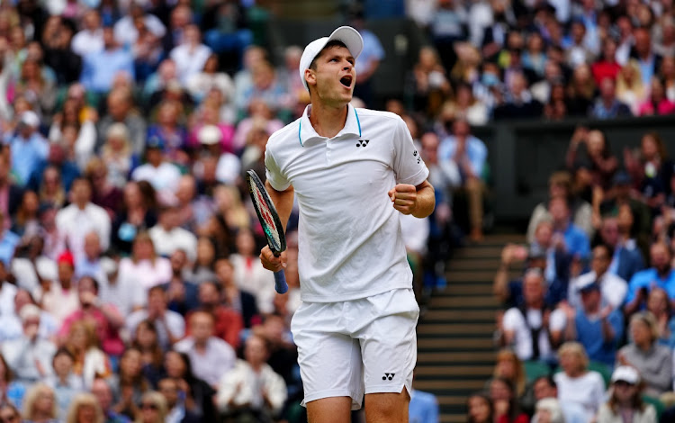 Hubert Hurkacz of Poland celebrates winning match point in his men's quarterfinal against Roger Federer of Switzerland in the Wimbledon Championship at the All England Lawn Tennis and Croquet Club on July 7, 2021 in London