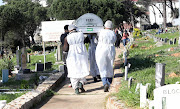 The sons of a Cape Town man who died from Covid-19 carry their father to his grave in Mowbray cemetery, Cape Town. File picture.