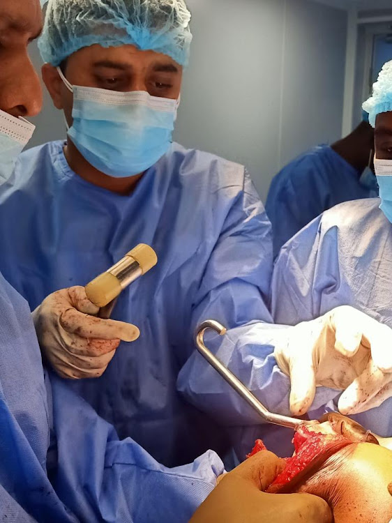 Senior orthopedic consultant Dr Kartikeya Joshi performs elbow replacement surgery on Samwel Njoroge at the Mediheal Hospital in Nairobi on April 26, 2021