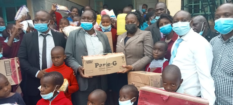 Bomet principal magistrate Lilian Kiniale with other judicial officers present foodstuffs to Umoja children's home in Bomet Central on Wednesday, June 16, 2021