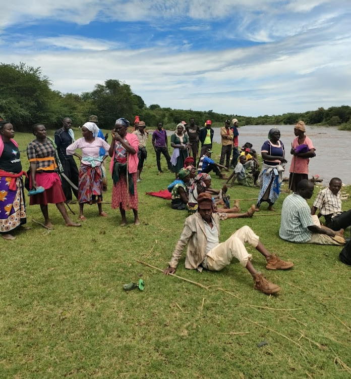 Residents of Kinyataa village in Yatta, Machakos County mill at the scene where a man reportedly drowned in banks of River Athi on April 9, 2024/ GEORGE OWITI